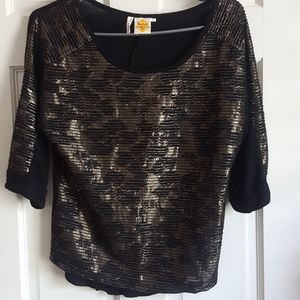 Available three quarter sleeve metallic top